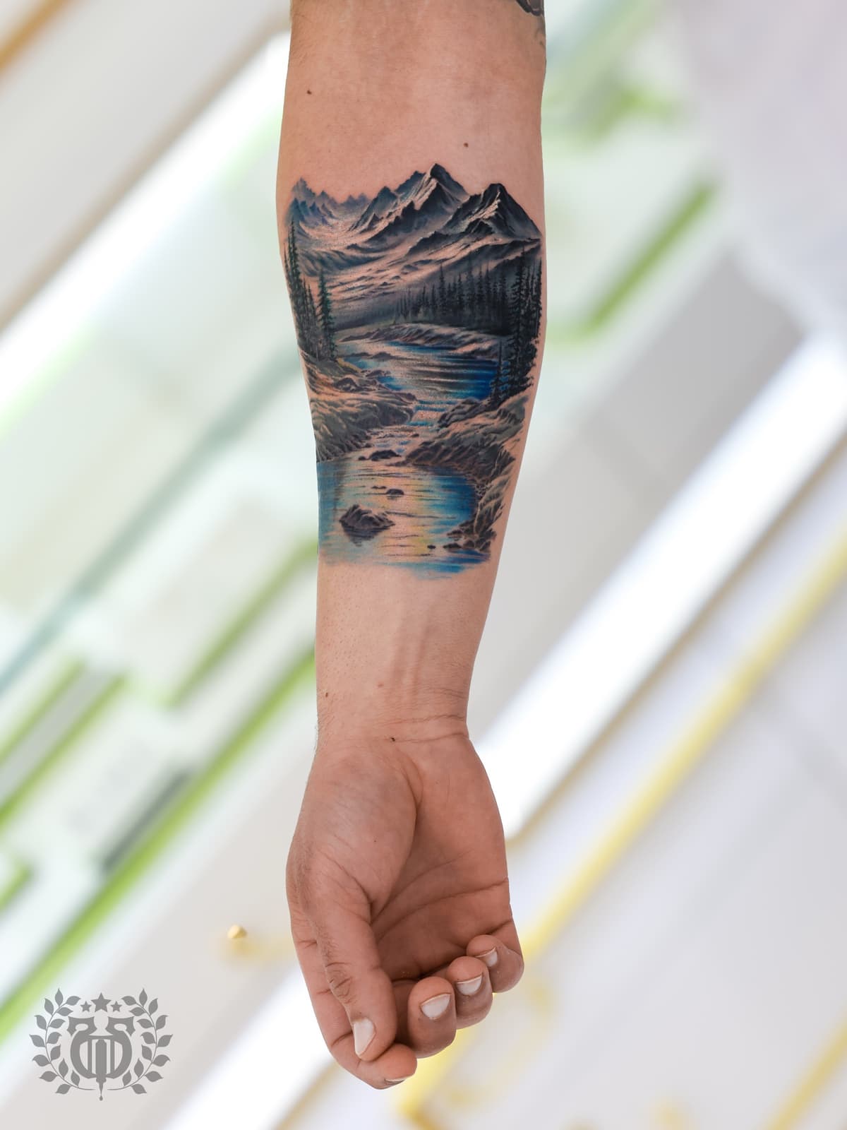 Color realistic mountain landscape with river wrap realism tattoo in Los Angeles