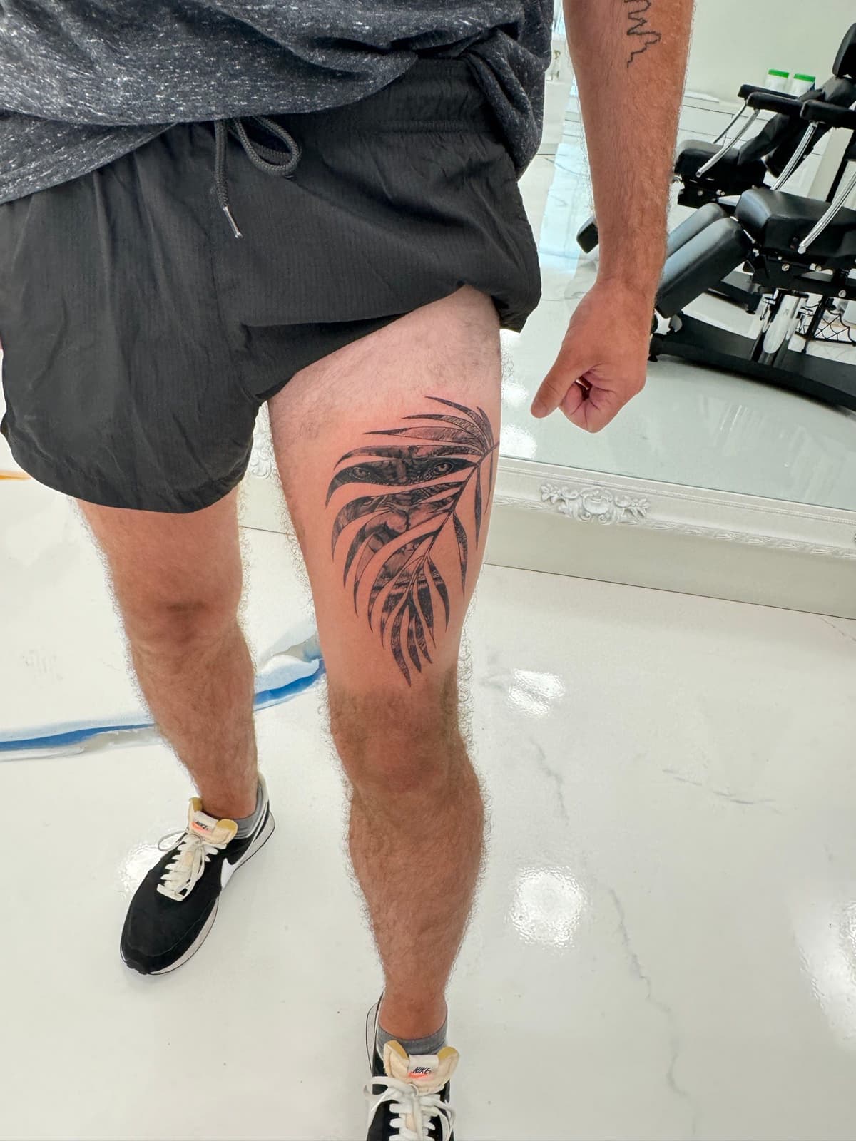 Black and grey realistic palm frond tropical leaf realism tattoo in Los Angeles