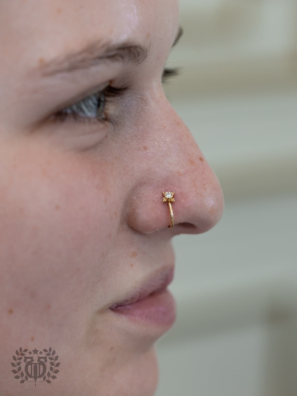 Expert piercer performing tongue piercing procedure at Apollo Studio