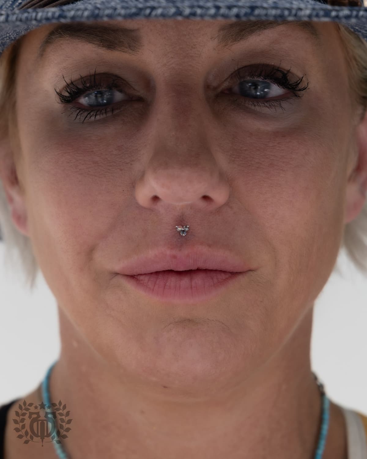 Medusa philtrum piercing with triple gemstone cluster full face portrait at Apollo Studio